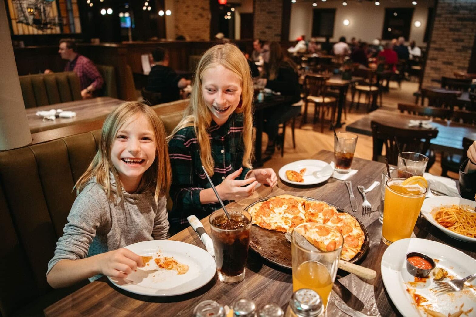 Happy children eating pizza at the green mill restaurant